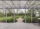 Patio with pergola, offering a view of the lush backyard and garden pathway for outdoor enjoyment at 31 N Restin Rd, Greenwood, IN 46142