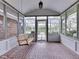 Enclosed back patio with brick flooring, swing, and white trim around the screens at 31 N Restin Rd, Greenwood, IN 46142