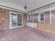 Screened patio with brick flooring, a cozy porch swing, and ample natural light at 31 N Restin Rd, Greenwood, IN 46142