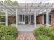 Charming patio featuring a screened-in porch, pergola, and brick pathway, perfect for outdoor living at 31 N Restin Rd, Greenwood, IN 46142