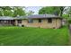 Expansive backyard with a lush lawn and privacy from the surrounding trees at 3412 Loral Dr, Anderson, IN 46013