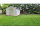 Backyard featuring storage shed with a well-maintained lawn, surrounded by mature trees at 3412 Loral Dr, Anderson, IN 46013