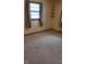 Cozy bedroom with patterned carpeting, natural light, and shelving at 3412 Loral Dr, Anderson, IN 46013
