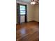 Bedroom features hardwood floors, a ceiling fan, and a window with natural light at 3412 Loral Dr, Anderson, IN 46013