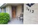 Inviting front porch area with seating, a welcome mat, and unique architectural details at 3412 Loral Dr, Anderson, IN 46013