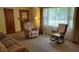 Inviting living room with comfortable furniture, natural light, and a rocking chair, perfect for relaxation at 3412 Loral Dr, Anderson, IN 46013