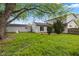 Large backyard with green grass, a detached garage, and a two-story home at 3425 N Elizabeth St, Indianapolis, IN 46226