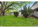 Backyard featuring lush greenery, mature trees, and a detached garage, perfect for outdoor activities at 3425 N Elizabeth St, Indianapolis, IN 46226