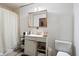 Modest bathroom with a standard sink, toilet, mirror, and shower at 3425 N Elizabeth St, Indianapolis, IN 46226