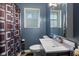 Well-lit bathroom with a modern vanity, toilet, large mirror, and a window providing natural light at 3425 N Elizabeth St, Indianapolis, IN 46226
