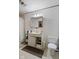 Simple bathroom includes a toilet, sink with cabinets, and neutral-toned shower curtain at 3425 N Elizabeth St, Indianapolis, IN 46226