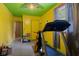 Yellow and green painted room featuring a treadmill and other exercise equipment at 3425 N Elizabeth St, Indianapolis, IN 46226