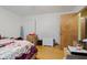 This bedroom features light hardwood floors, boxes, a door, and a heater at 3425 N Elizabeth St, Indianapolis, IN 46226