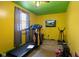 Brightly painted workout room featuring a treadmill, exercise bike, and window at 3425 N Elizabeth St, Indianapolis, IN 46226