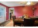 Dining area featuring a wood table, four chairs, and red accent walls at 3425 N Elizabeth St, Indianapolis, IN 46226