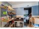 Traditional kitchen with stainless steel oven and shelving, alongside laundry area at 3425 N Elizabeth St, Indianapolis, IN 46226