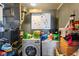 Functional laundry room with a front load washing machine and dryer, plus extra storage at 3425 N Elizabeth St, Indianapolis, IN 46226