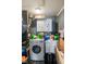 Functional laundry room with a front load washing machine and dryer, plus extra storage at 3425 N Elizabeth St, Indianapolis, IN 46226