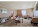 Cozy living room with neutral walls, carpet flooring, and bright natural light from a large window at 3425 N Elizabeth St, Indianapolis, IN 46226