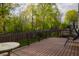 A well-maintained wood deck and fenced-in yard provide outdoor living space with mature trees and a swing at 3438 Windy Knoll Ln, Carmel, IN 46074