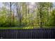A privacy fence encloses the backyard with mature trees adding shade and privacy at 3438 Windy Knoll Ln, Carmel, IN 46074