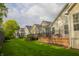 Row of houses overlooking a green yard and brown wood decks on a sunny day at 3438 Windy Knoll Ln, Carmel, IN 46074
