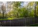 A wood fence encloses the backyard, offering a lush view of trees and grass at 3438 Windy Knoll Ln, Carmel, IN 46074