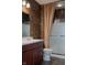 Well-lit bathroom with dark wood vanity, white countertops, and a glass enclosed shower at 3438 Windy Knoll Ln, Carmel, IN 46074