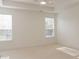 Bright bedroom featuring plush carpeting, tray ceiling and two large windows allowing natural light at 3438 Windy Knoll Ln, Carmel, IN 46074