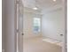 Spacious bedroom boasts neutral carpet, a ceiling fan, and a large window for natural light at 3438 Windy Knoll Ln, Carmel, IN 46074