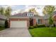 Attractive home with a two-car garage, brick facade, and meticulously maintained lawn at 3438 Windy Knoll Ln, Carmel, IN 46074