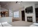 Open-concept room with fireplace, built-ins, and adjacent kitchen area at 3438 Windy Knoll Ln, Carmel, IN 46074