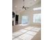 Sun-drenched living area with fireplace, built-in bookcase, and large windows at 3438 Windy Knoll Ln, Carmel, IN 46074
