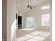 Bright, open living area with a ceiling fan and large windows at 3438 Windy Knoll Ln, Carmel, IN 46074
