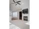 Bright living room with a fireplace, ceiling fan and built in bookcase at 3438 Windy Knoll Ln, Carmel, IN 46074