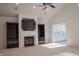 Open living room with fireplace and built-in shelving and media center at 3438 Windy Knoll Ln, Carmel, IN 46074