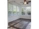 Bright sunroom features a ceiling fan, tile flooring, and lots of natural light from many windows at 3438 Windy Knoll Ln, Carmel, IN 46074