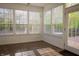 Sunroom with tiled floor and multiple windows overlooking a well maintained outdoor living space at 3438 Windy Knoll Ln, Carmel, IN 46074
