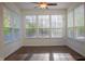Sunroom with tile floor and ceiling fan offering ample natural light through large windows at 3438 Windy Knoll Ln, Carmel, IN 46074
