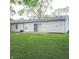 Backyard exterior featuring a sliding glass door and ample yard space with mature trees at 3453 Payton Ave, Indianapolis, IN 46226