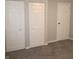 This bedroom features neutral walls and gray carpeting and two separate closets for plenty of storage space at 3453 Payton Ave, Indianapolis, IN 46226