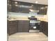 Kitchen featuring stainless steel appliances, wooden cabinets, and laminate countertops at 3453 Payton Ave, Indianapolis, IN 46226