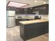 Kitchen featuring stainless steel appliances, a breakfast bar, and dark cabinets at 3453 Payton Ave, Indianapolis, IN 46226
