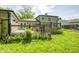 Yard features a deck, grass, and an area with purple flowers at 3514 Eisenhower Dr, Indianapolis, IN 46224