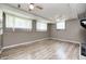 View of a finished basement with new floors, multiple windows and ceiling fans at 3514 Eisenhower Dr, Indianapolis, IN 46224