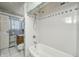 Close-up of a white tiled shower and bathtub in bathroom at 3514 Eisenhower Dr, Indianapolis, IN 46224