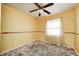 Bedroom featuring a ceiling fan, window and wood trim at 3514 Eisenhower Dr, Indianapolis, IN 46224