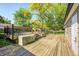 Wooden deck with dark railing and a view of mature trees and greenery at 3514 Eisenhower Dr, Indianapolis, IN 46224