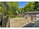 Exterior wood deck with railings overlooking the backyard and red shed at 3514 Eisenhower Dr, Indianapolis, IN 46224