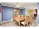 Cozy dining room with blue walls, a wooden table, and a lovely hutch for displaying items at 3514 Eisenhower Dr, Indianapolis, IN 46224